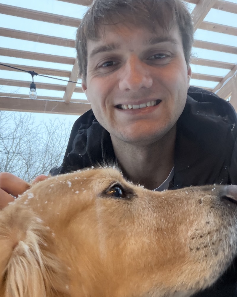 Michael Boling outdoors with his dog.
